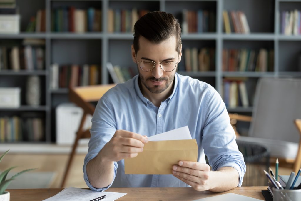 Man receiving stimulus check - Moseman Law Office